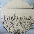 Decorative sign with gingerbread men and the word 'Welcome' on a green background