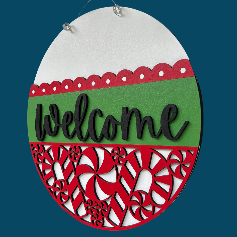 Decorative sign with 'Welcome' text on a green and red background