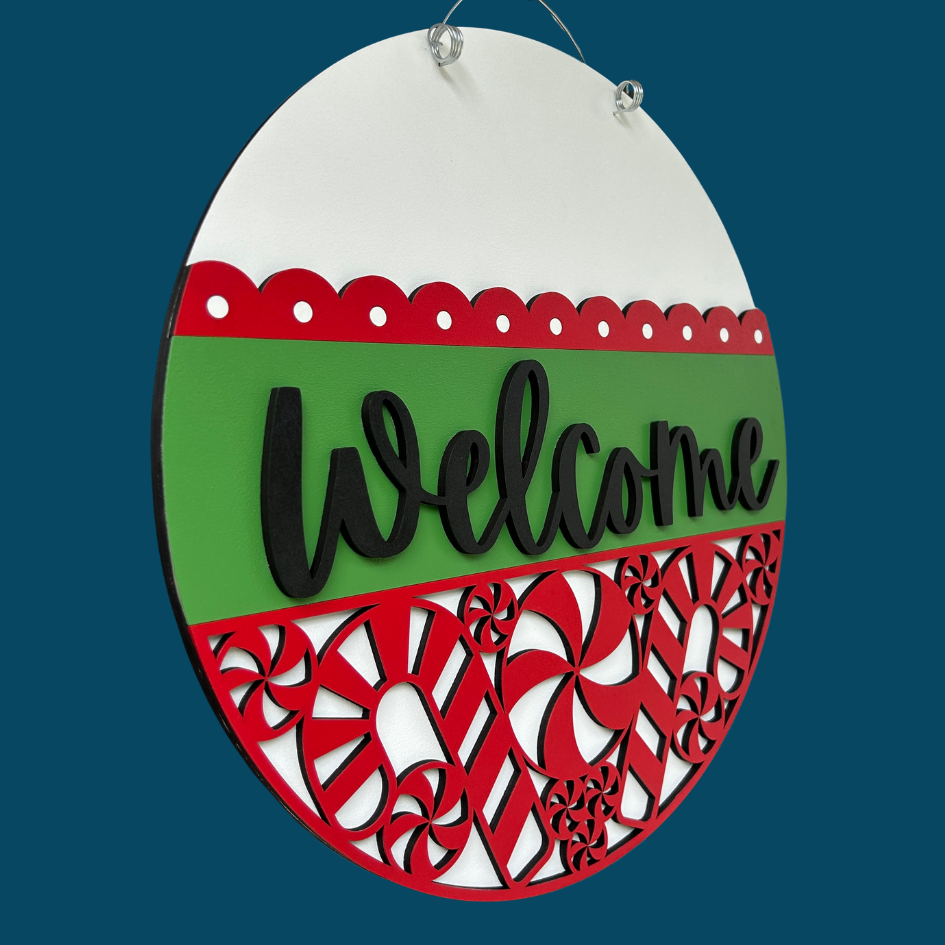 Decorative sign with 'Welcome' text on a green and red background