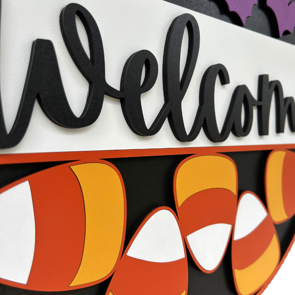 Halloween-themed 'Welcome' sign with candy corn design