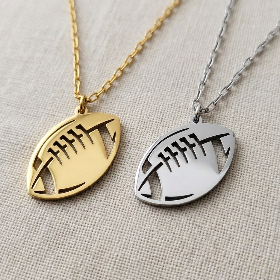Gold and silver necklaces with eye-shaped pendants on a textured beige background