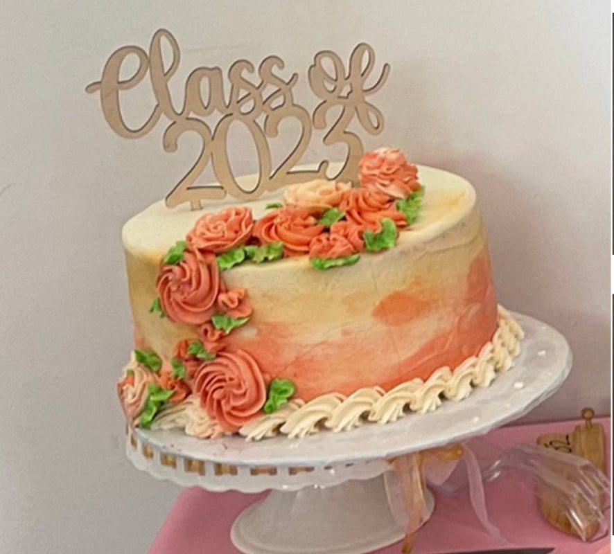 Graduation Cake Topper in a beautifully decorated cake.