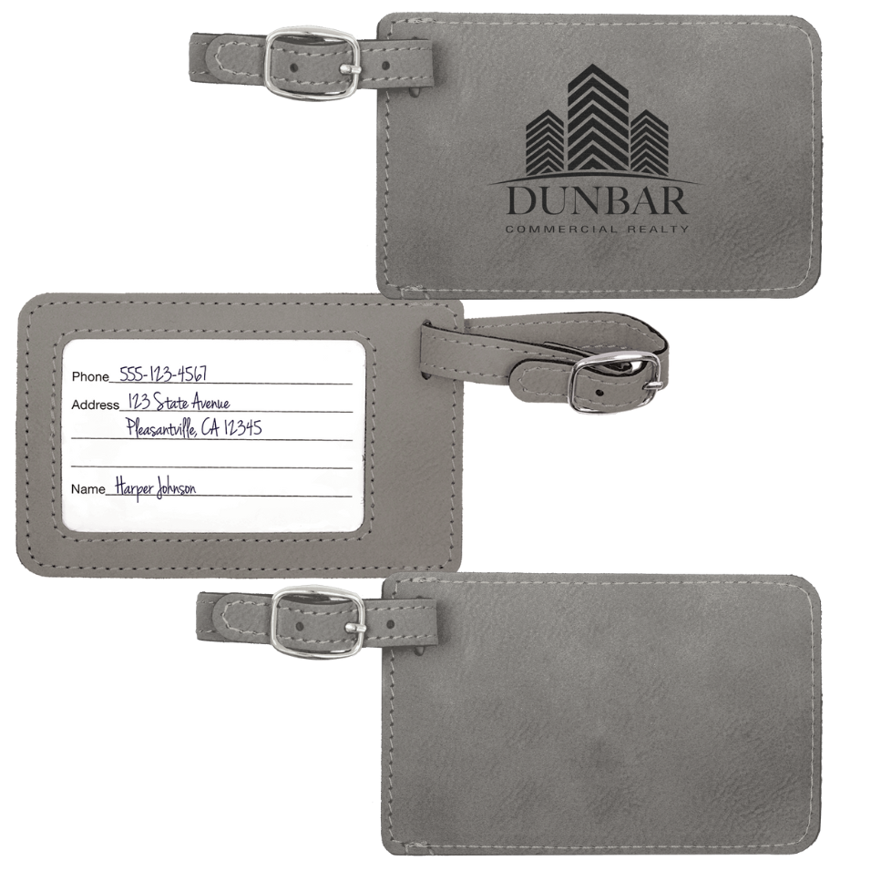 Three gray luggage tags with engraved text and branding on a white background