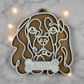 Adorable line art Caliver King Charles Spaniel ornament with the name Buddy on a dog bone.