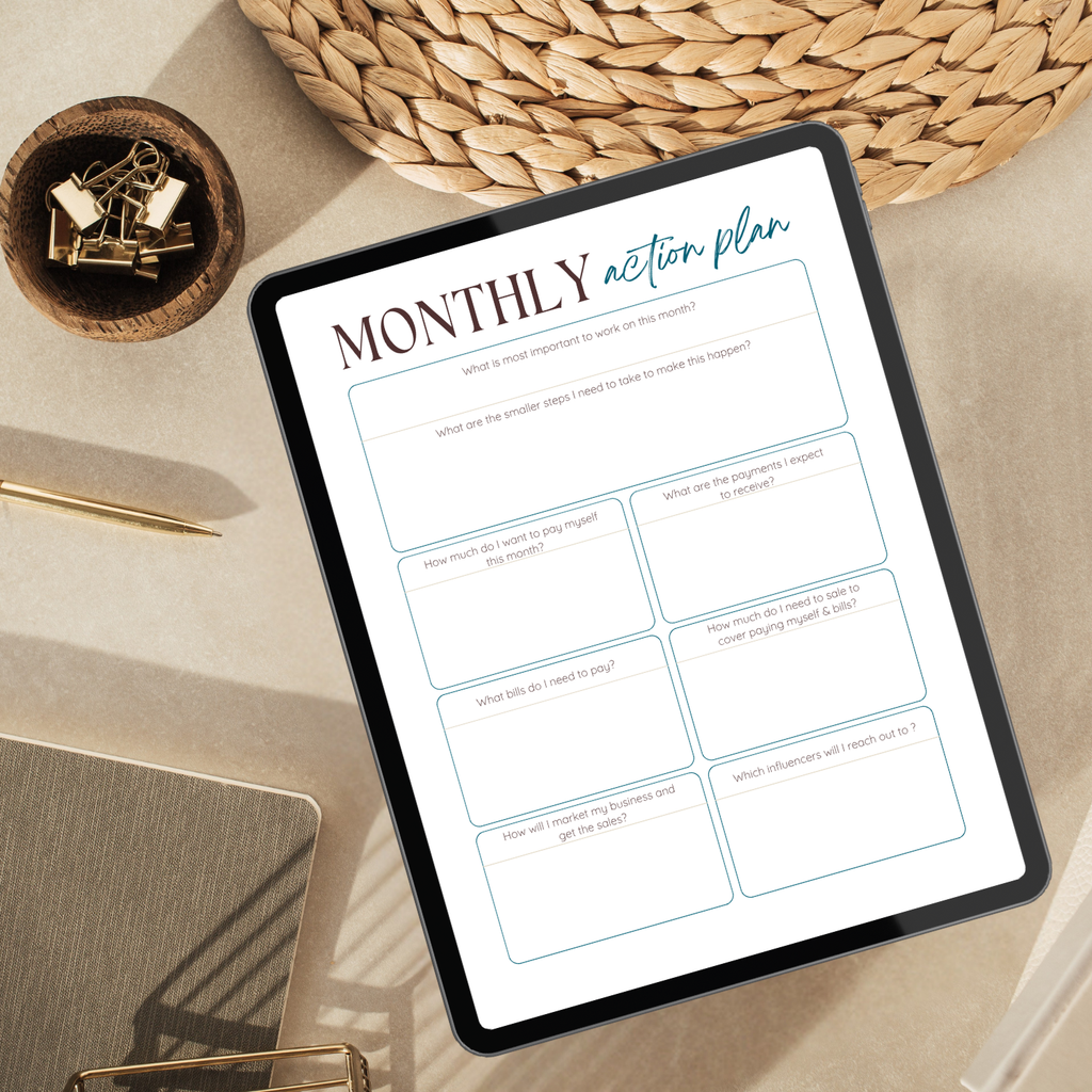 Tablet displaying a 'Monthly Action Plan' on a desk with office supplies.