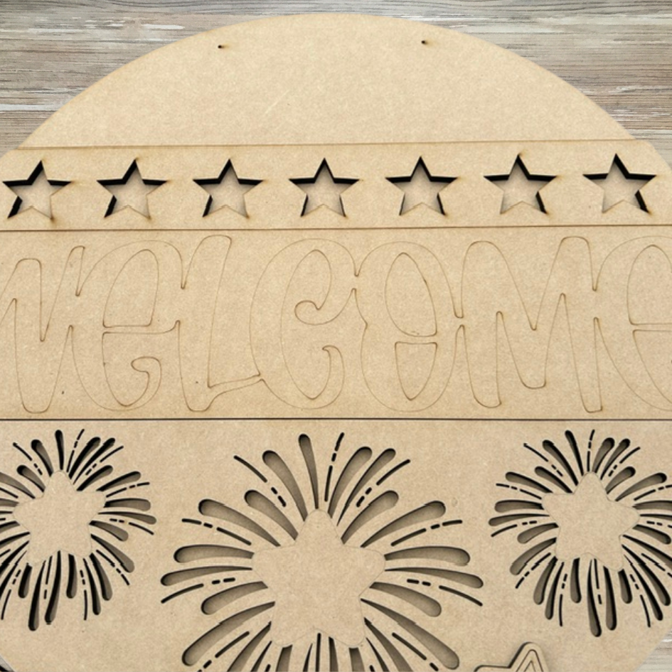 Wooden welcome sign with star and floral patterns on a wooden surface
