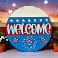 Round decorative sign with 'WELCOME' text and star designs, set against a sunset sky.
