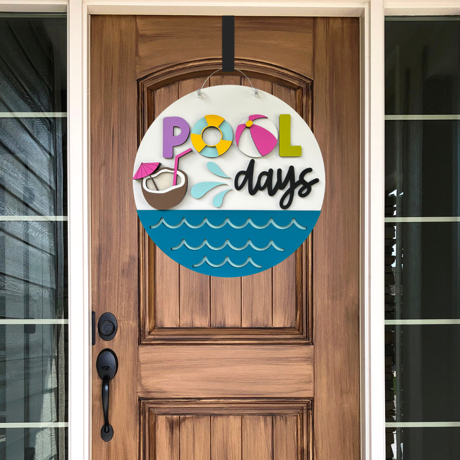 Decorative sign with 'Pool days' text on a wooden door