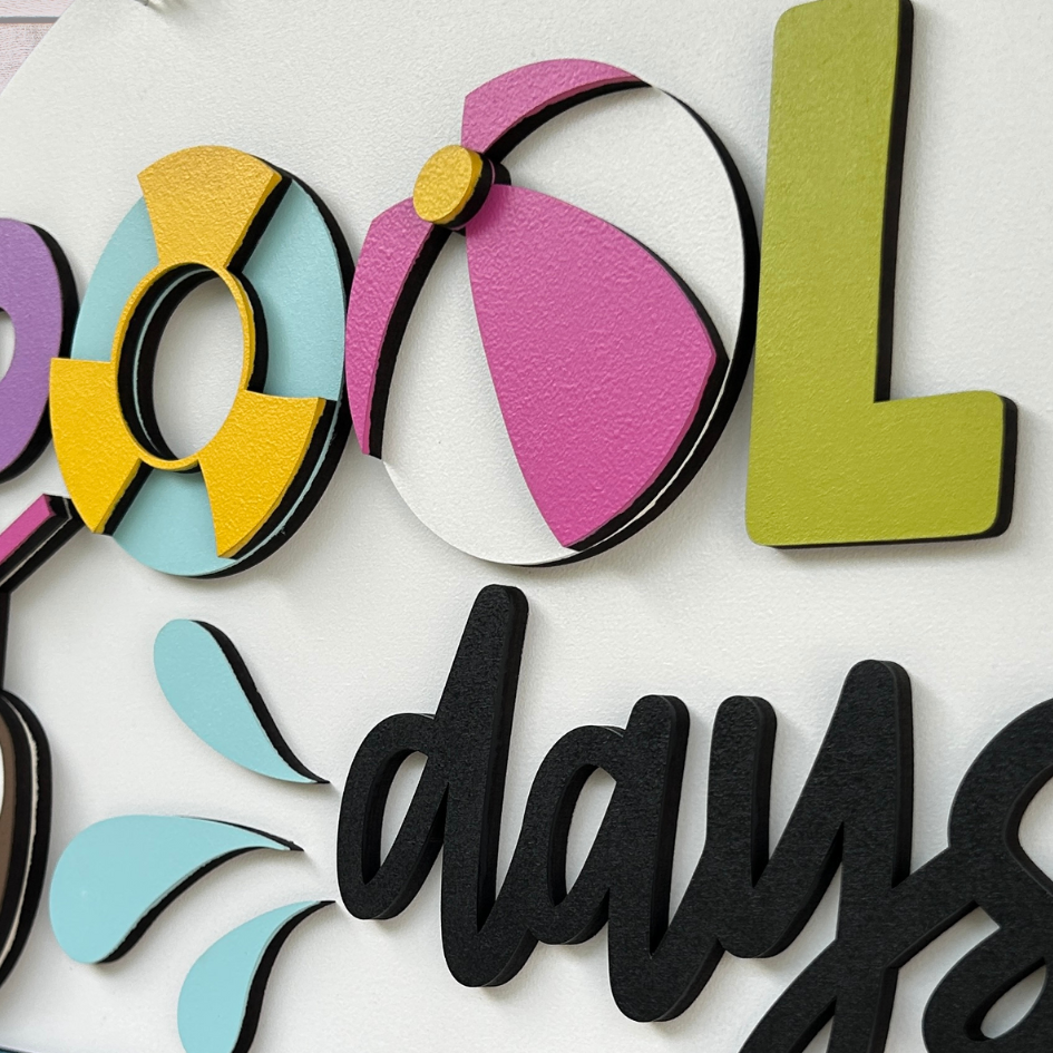 Close up of the Pool Days door sign showing the 3d layers.