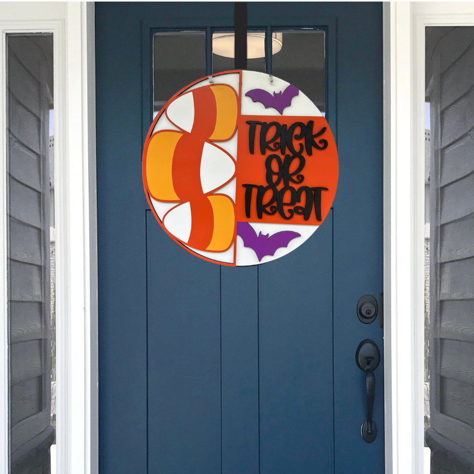 Halloween-themed door decal with candy corn design and 'Trick or Treat' text on a blue door.