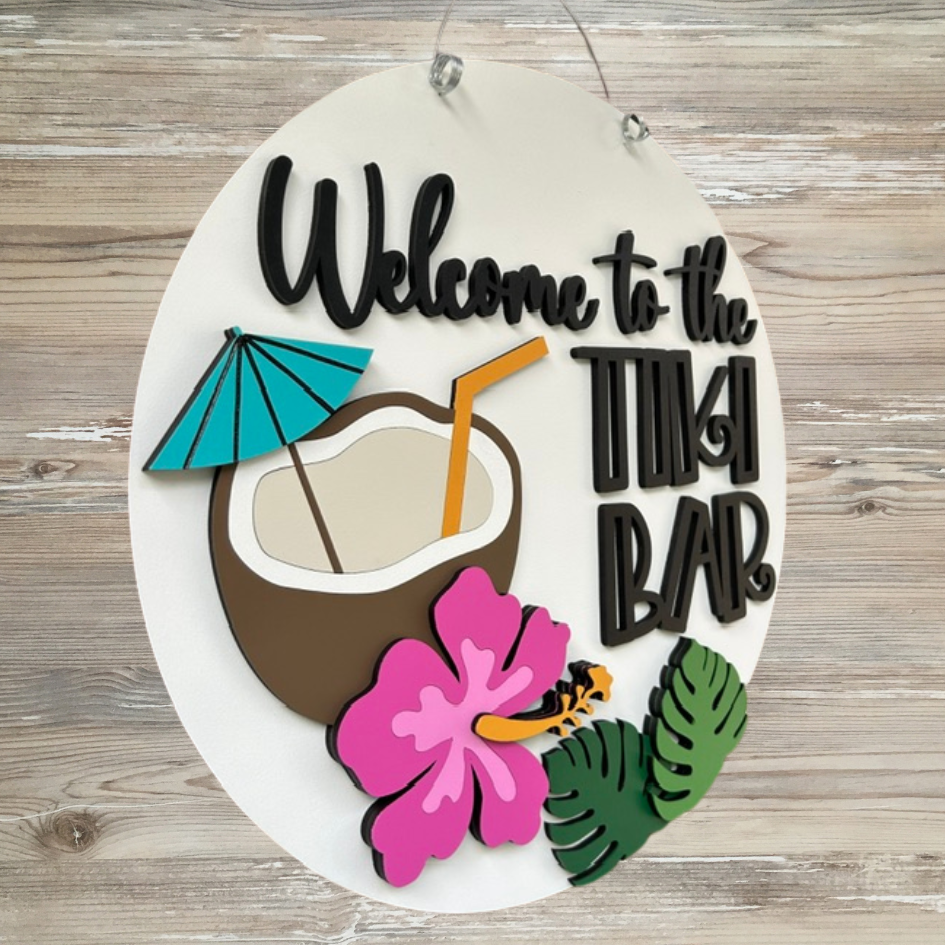 Decorative sign with coconut, umbrella, straw, and flowers on a wooden background