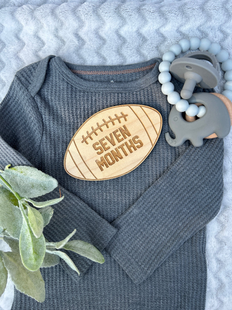 Baby football milestone photo prop for seven months.
