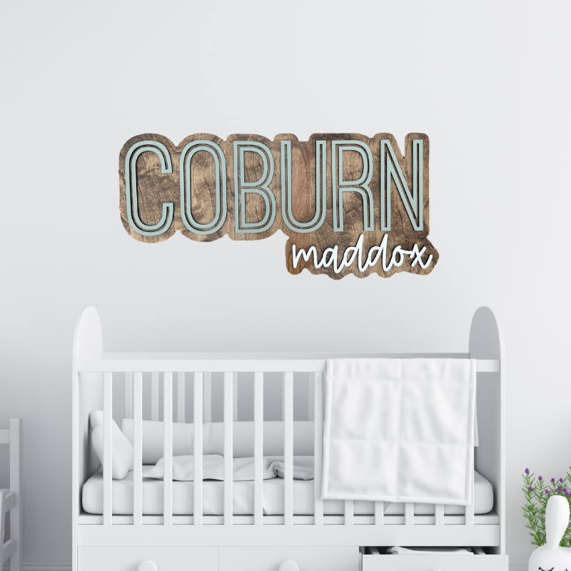 Baby Name cut out and outlined with a wood backer.