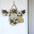 Sign in the shape of a cow head with an ear tag where you can write the new baby stats.