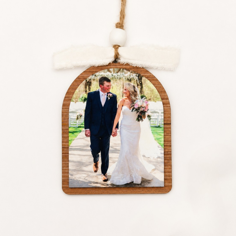 Wooden photo ornament with a wedding couple on a white background