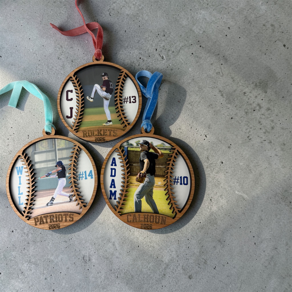Three personalized baseball ornaments with player images and names on a concrete surface.