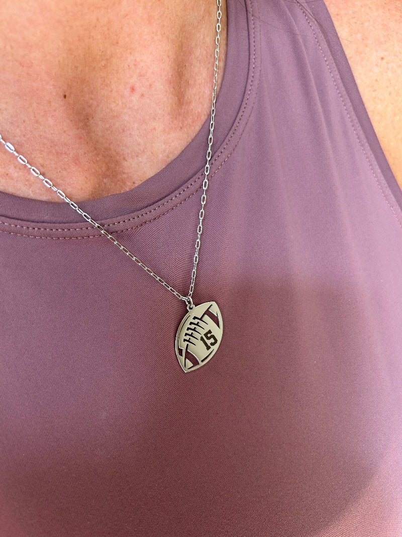 Silver stainless steel engraved necklace being worn.