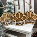 3 dog paw ornaments showing the normal paw and a paw with wings. All 3 have a dogs name on them.