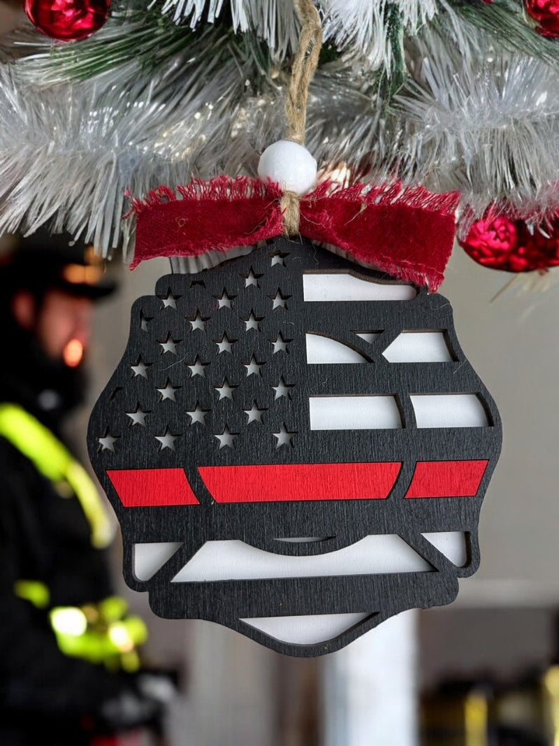 Fireman badge ornament hanging on a tree.
