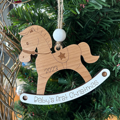 Personalized rocking horse ornament for baby's first Christmas.
