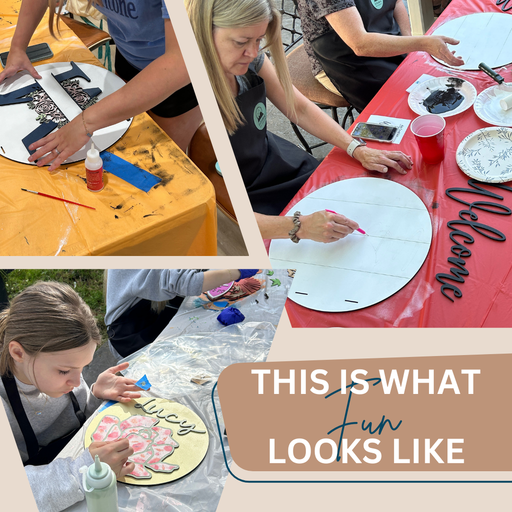 People working on their signs at a paint party.
