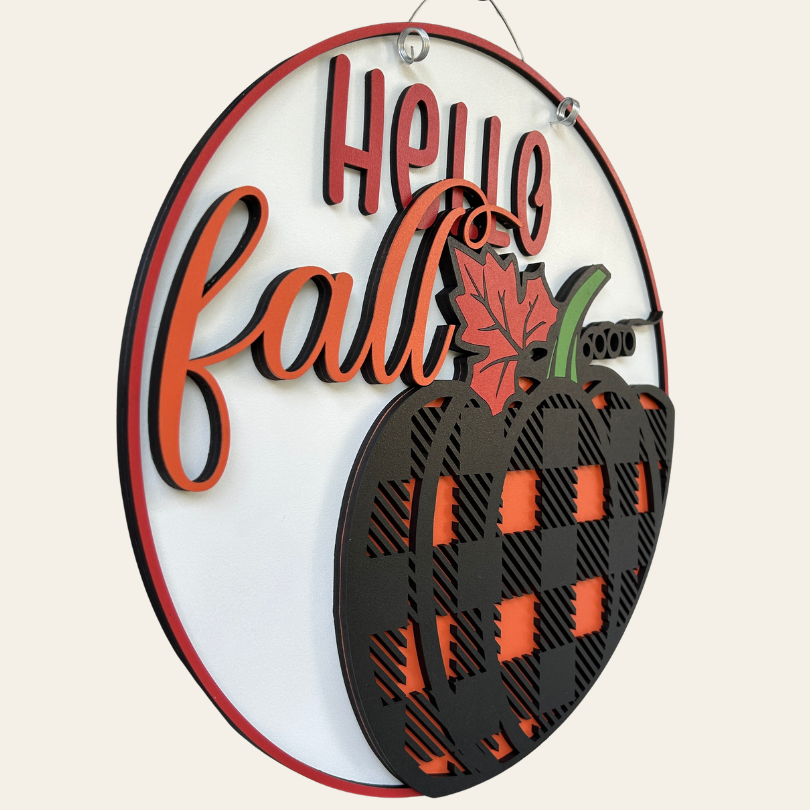 Decorative sign with 'Hello Fall' text and pumpkin design on a white background