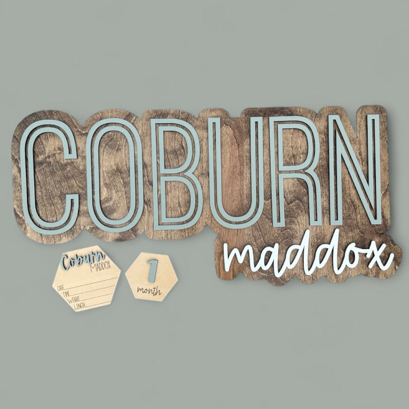 Baby Name cut out and outlined with a wood backer.