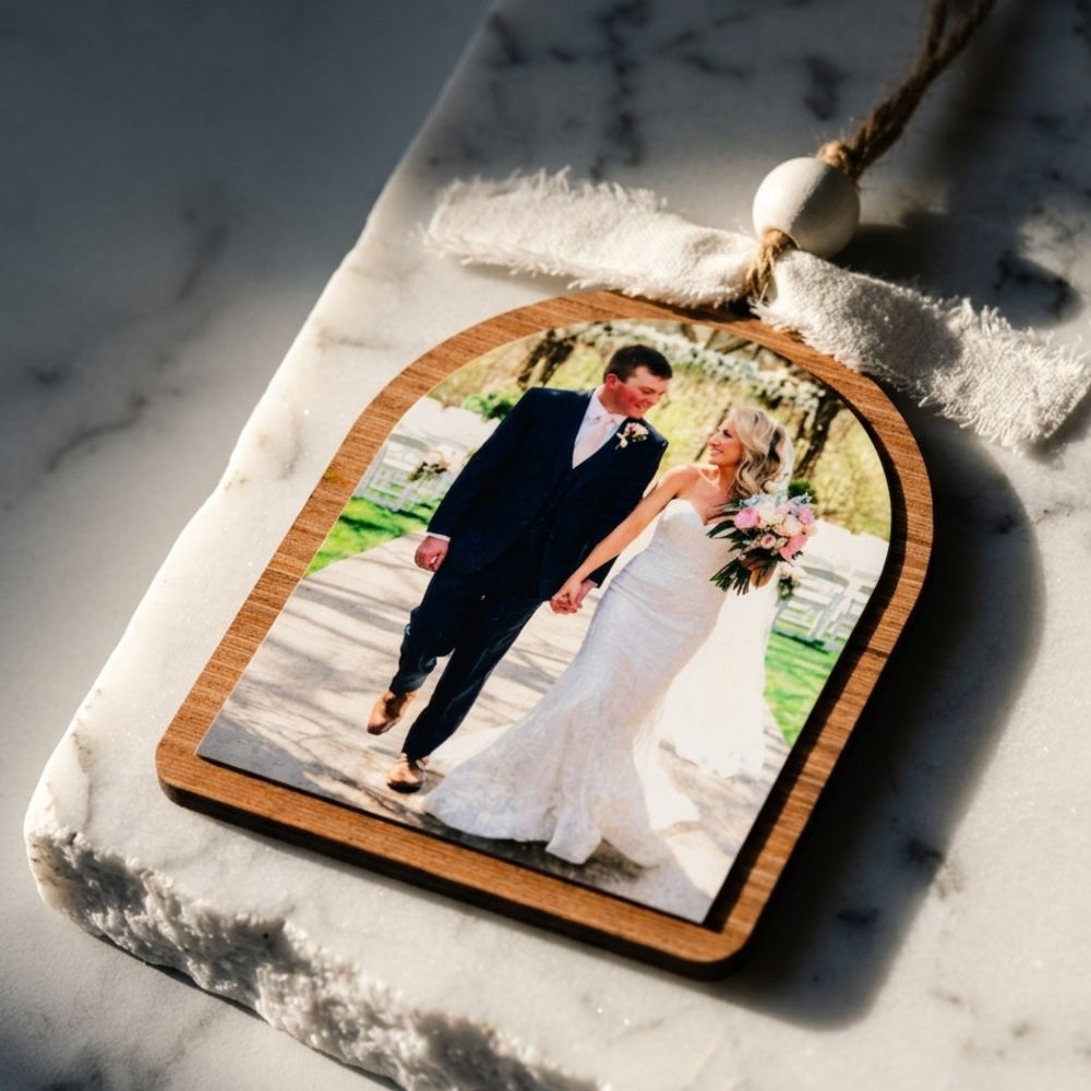 Wooden photo ornament with a wedding couple on a marble surface
