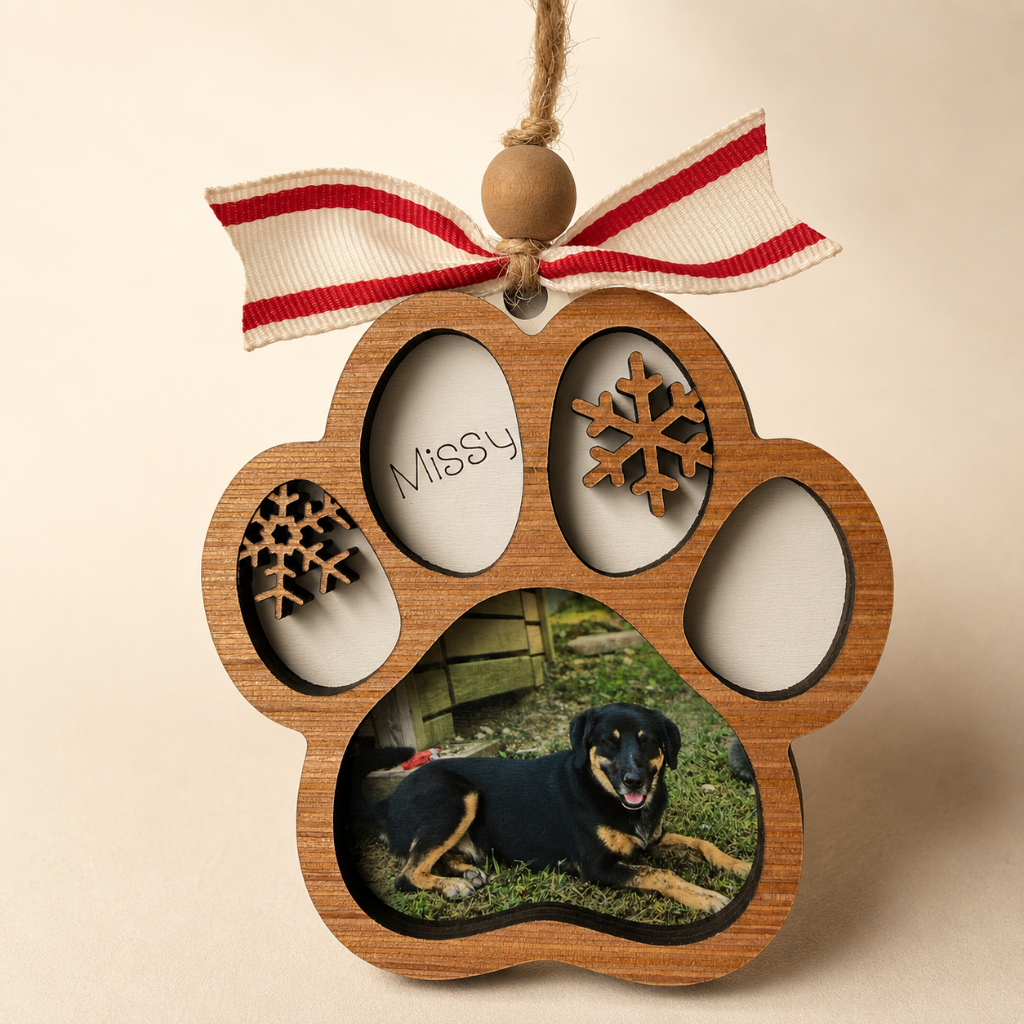 Wooden paw-shaped photo frame with a dog picture and 'Missy' text, hanging on a beige background.