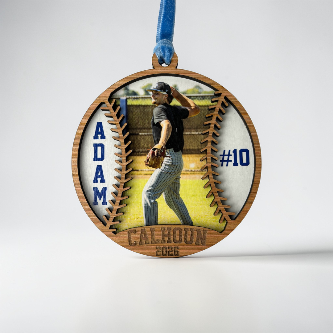 Wooden ornament with a baseball player image and text on a white background