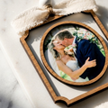 Rectangle wooden frame with a photo of a couple kissing inside an oval frame, placed on a marble surface.