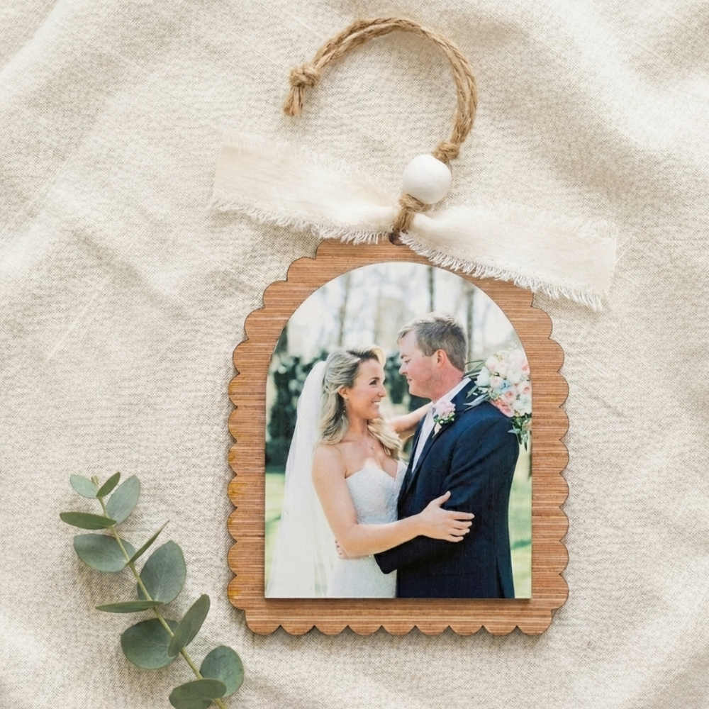 Wooden photo ornament with a couple's picture on a textured beige background