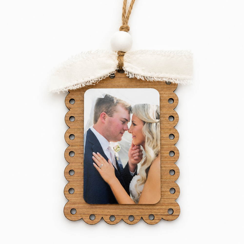 Wooden photo frame with a couple's photo on a white background