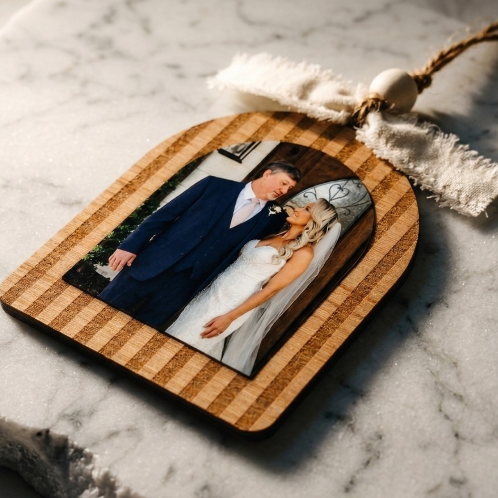 Wooden ornament with a photo of a father and daughter on a marble surface