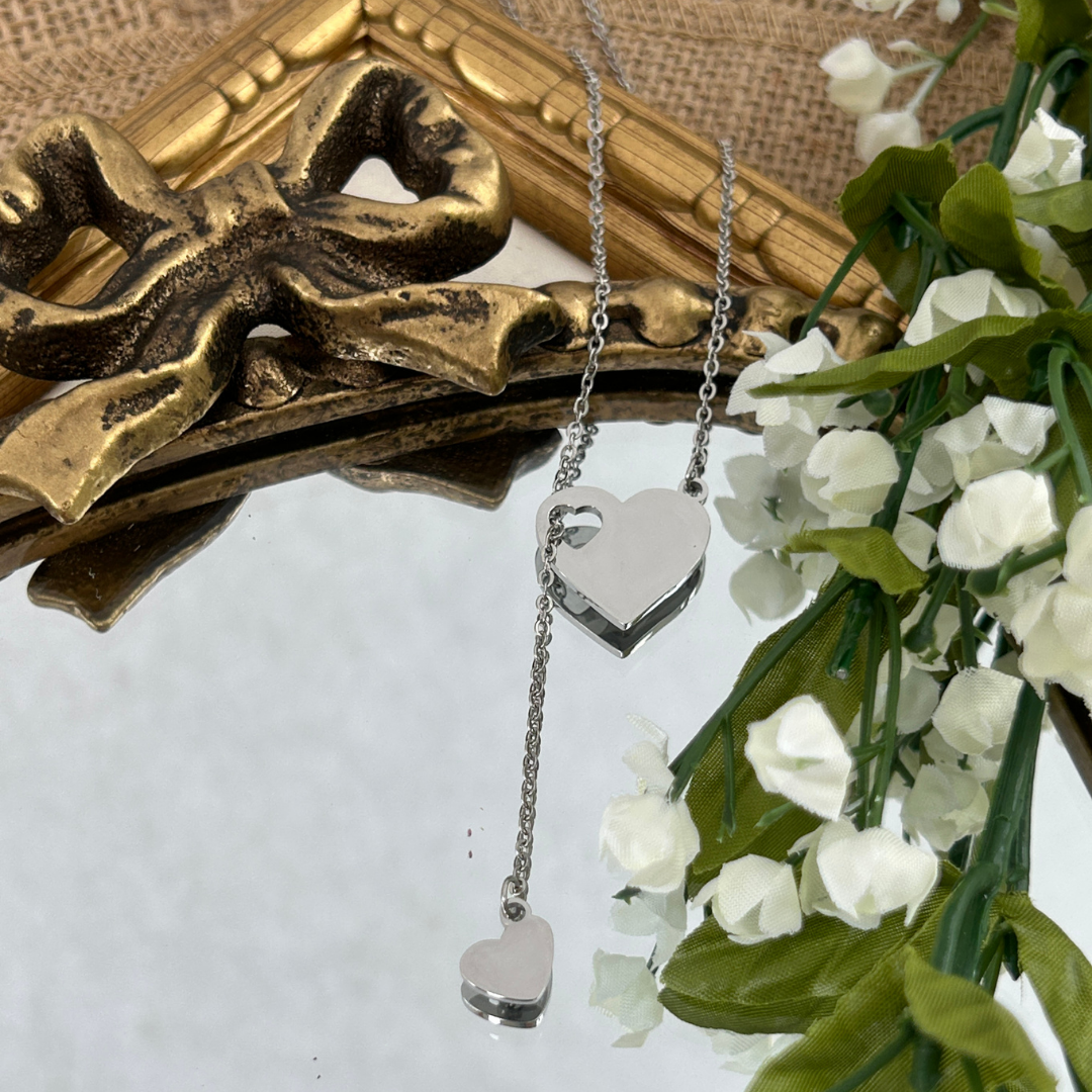 Silver heart-shaped pendant necklace with floral and decorative background