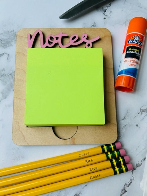 Sticky note holder for teachers desk