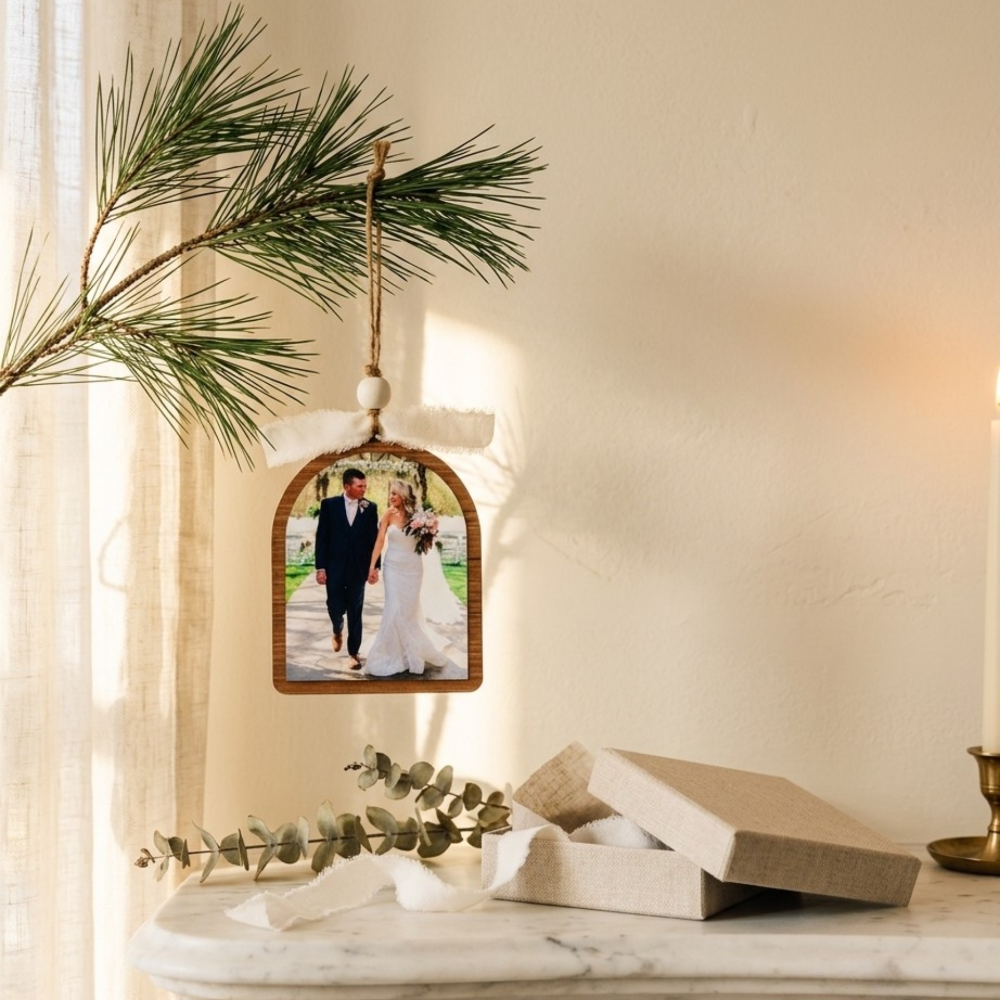 Decorative photo ornament with a couple on a marble surface with greenery