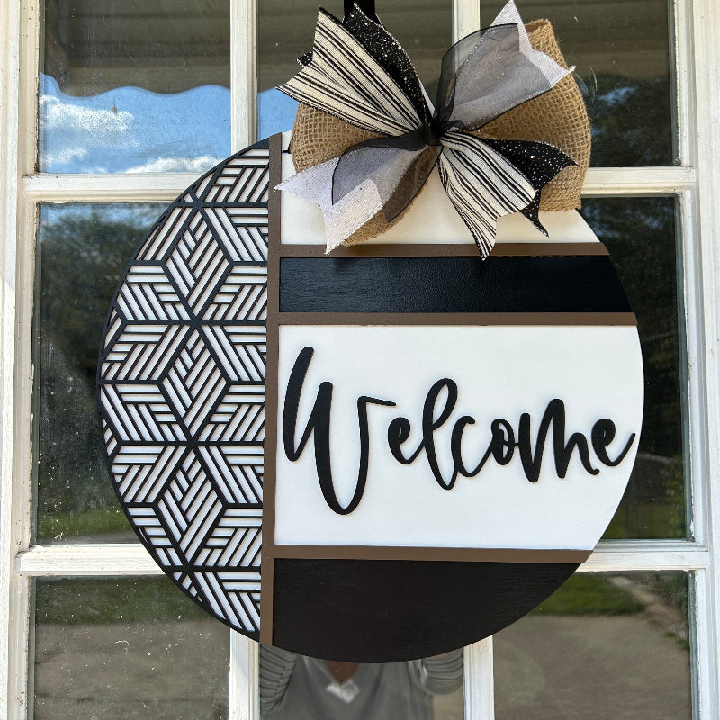 Aztec design Welcome sign hanging on a front door.