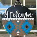 Aztec design Welcome sign hanging on a front door.