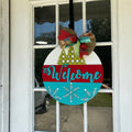 Buffalo Plaid Pine Tree design Welcome sign hanging on a front door.