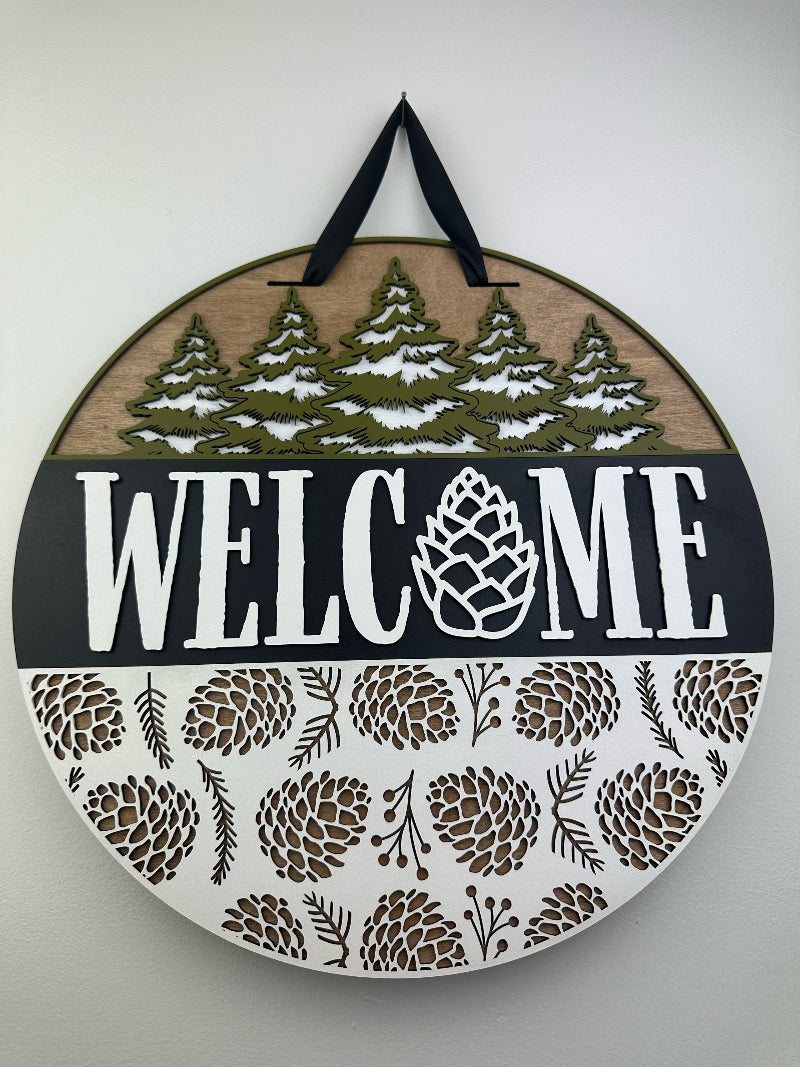 Welcome sign with Pinecones for a front door.