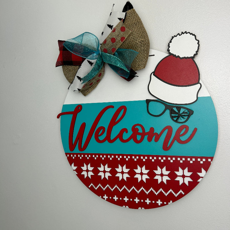 Welcome door sign with the Christmas Story Ralphie's tobogan and broken glasses.