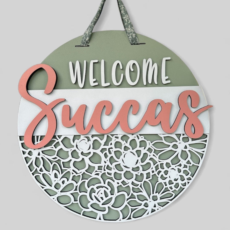 Welcome Succas with plants at the bottom for a front door.
