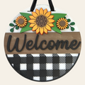 Round wooden sign with sunflowers and 'Welcome' text on a checkered background